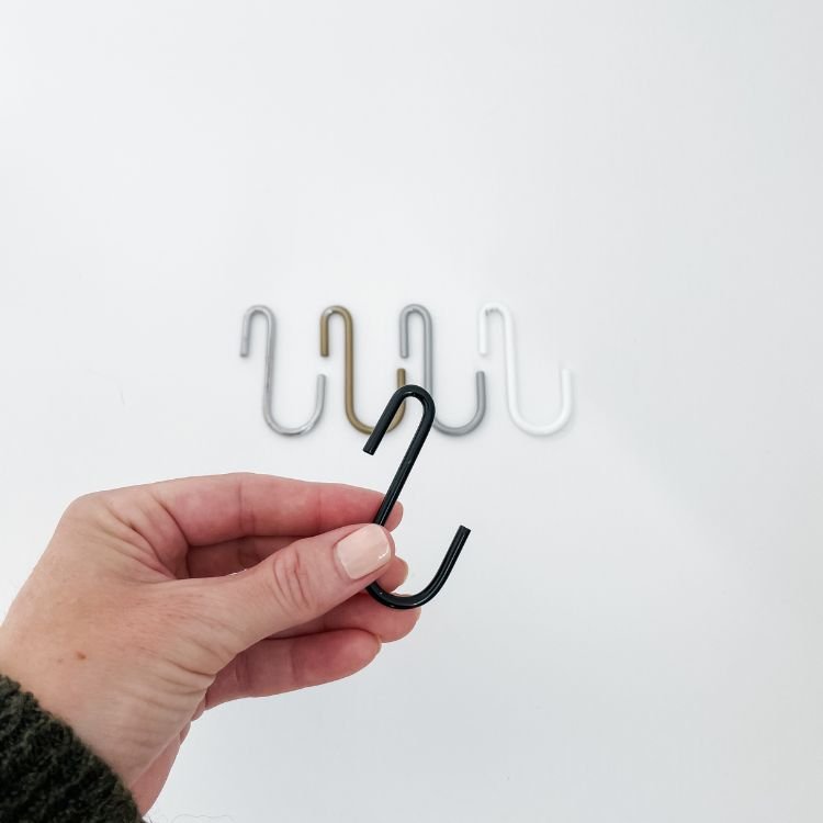hand holding black s hook