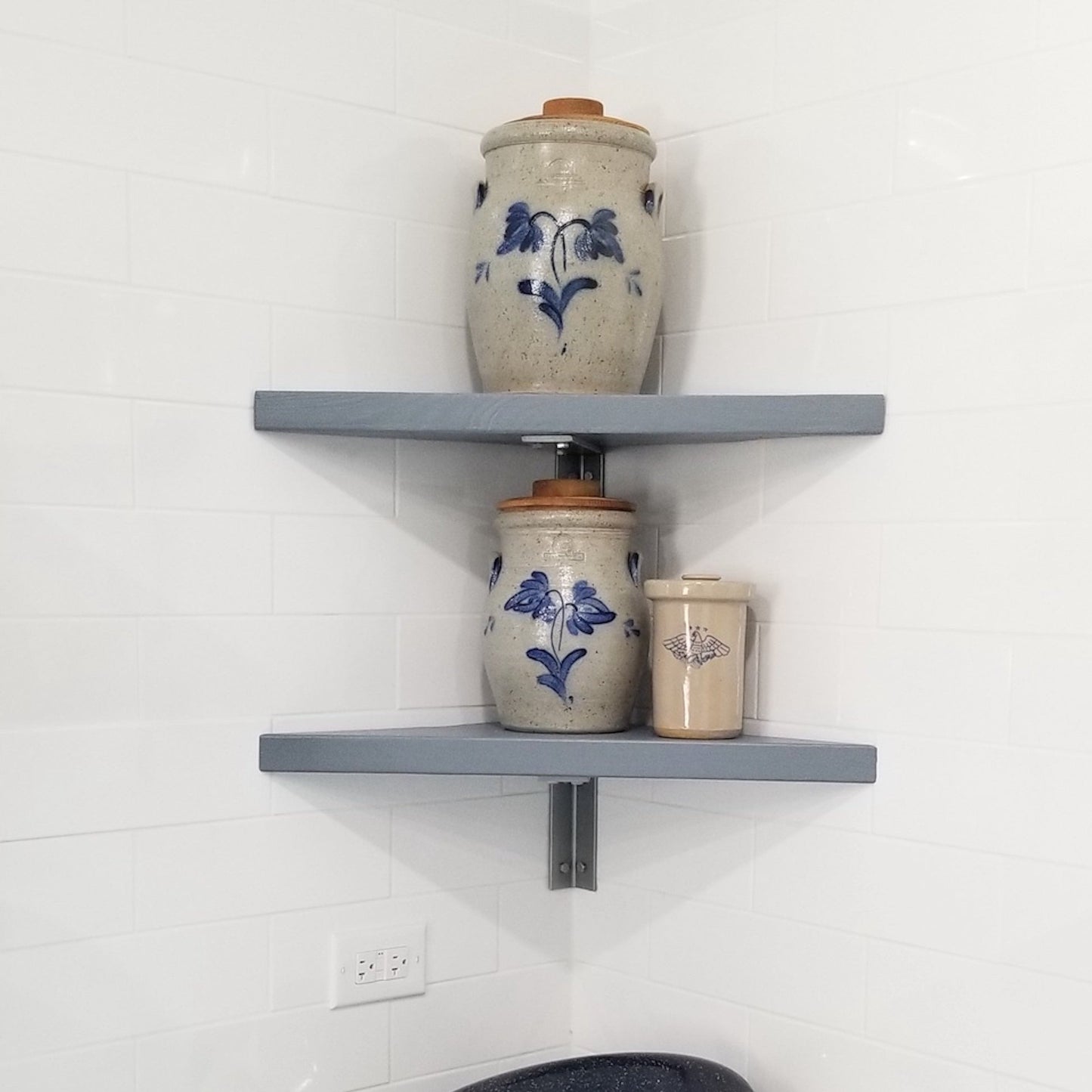 two gray shelves with silver corner shelf brackets