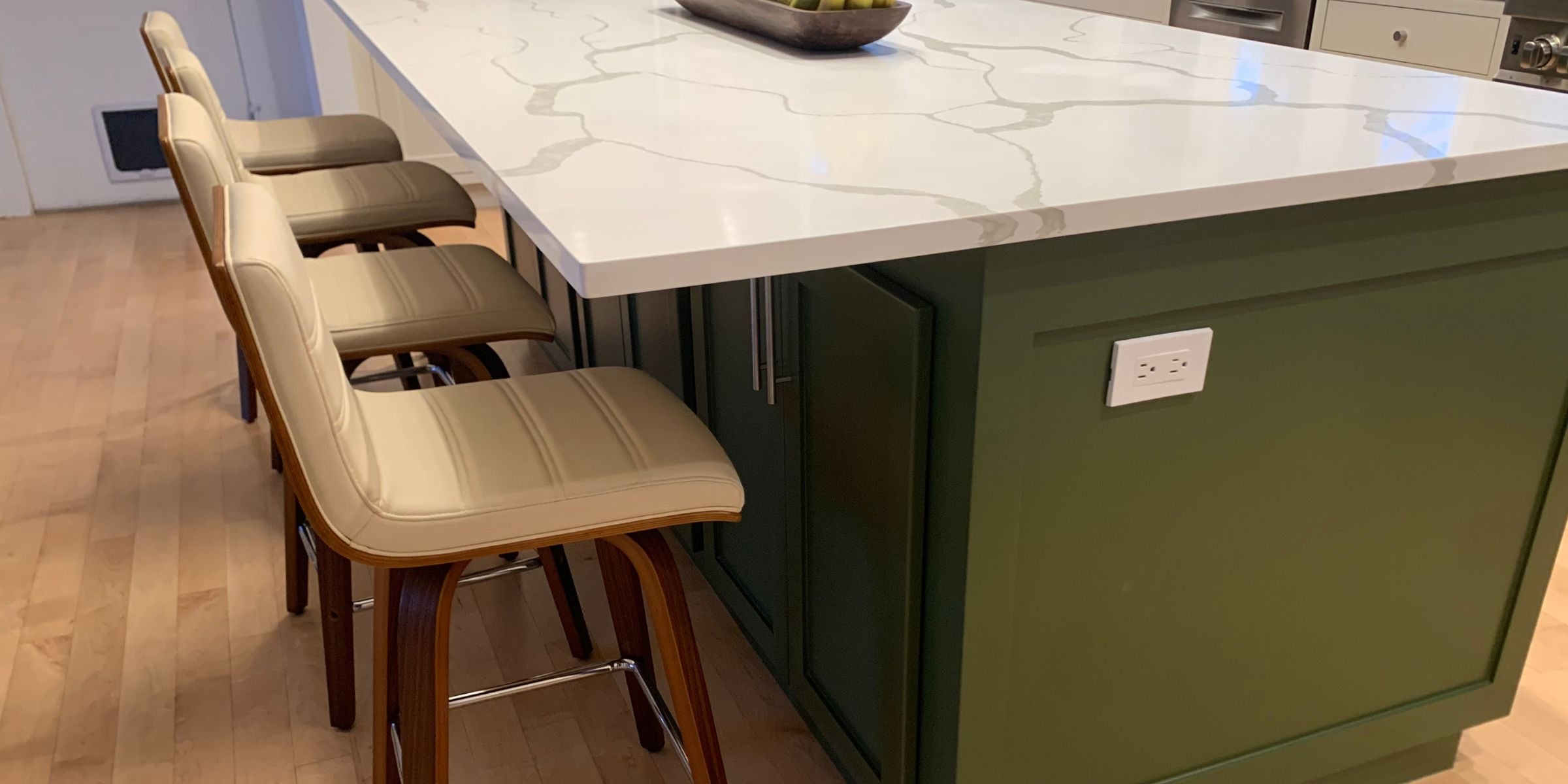 green kitchen island with white marble countertop