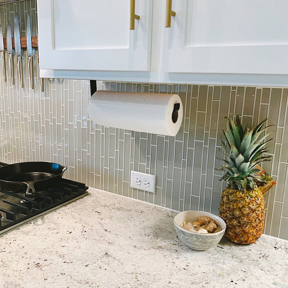 Black Paper Towel Holder installed under white kitchen cabinets with sage green tile backsplash