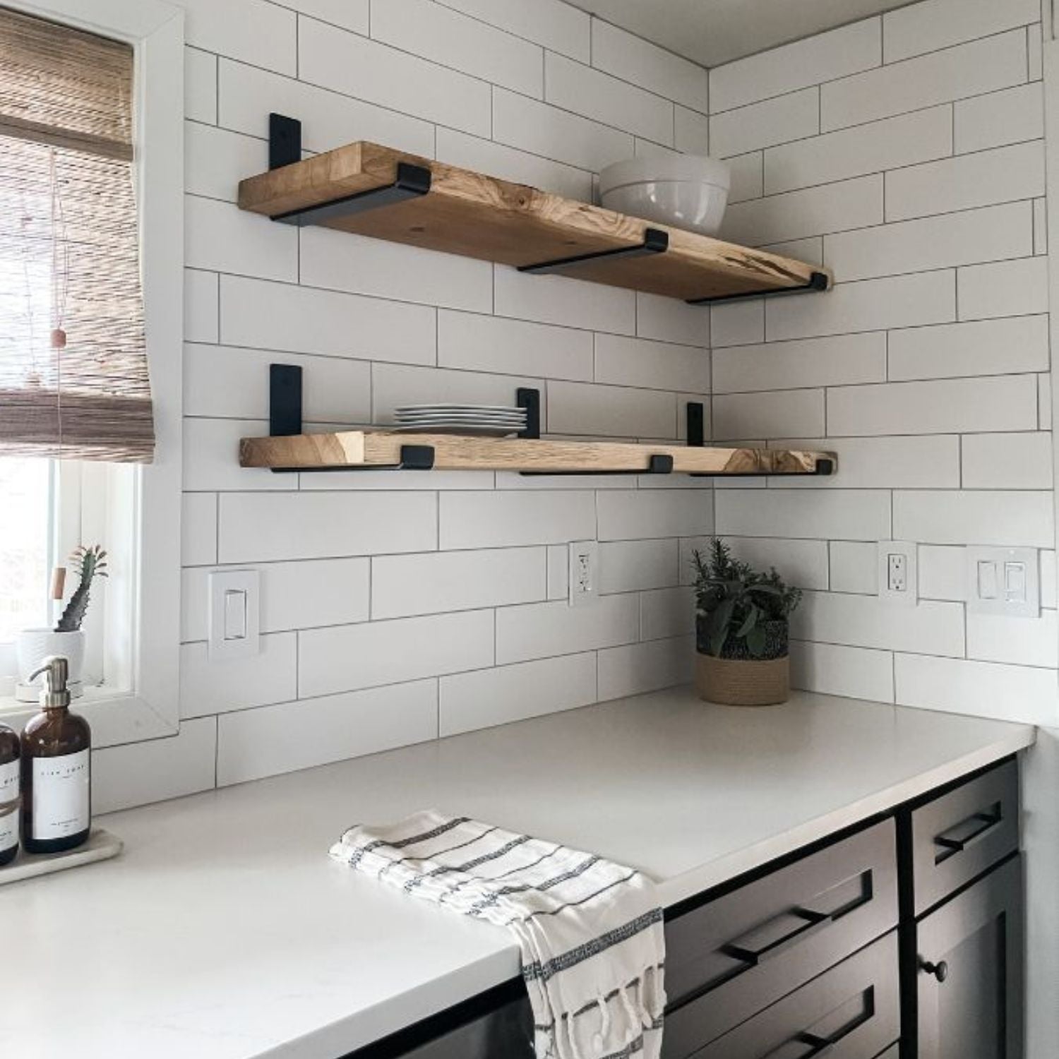 black and white kitchen with wood shelves