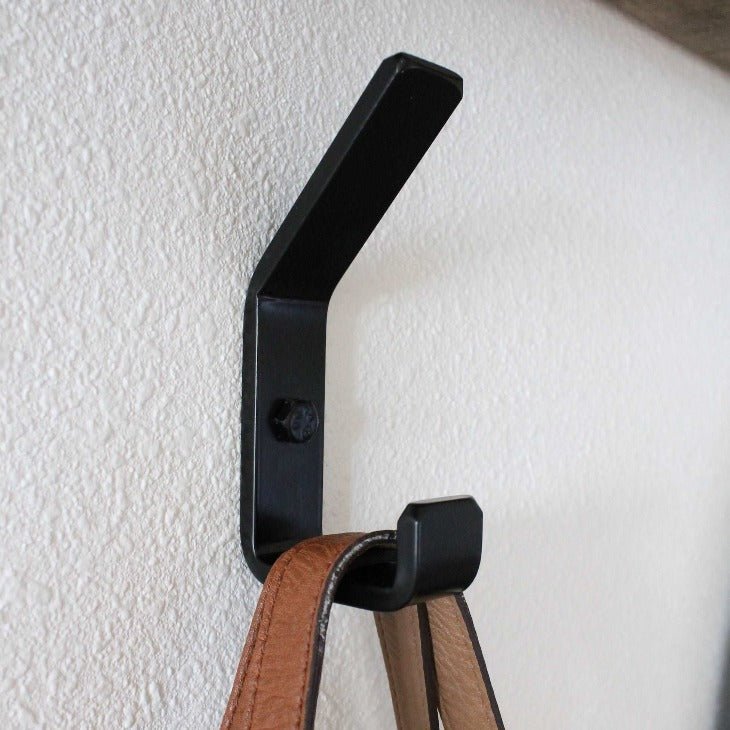 black Metal Double Hook mounted on wall with brown bag hanging