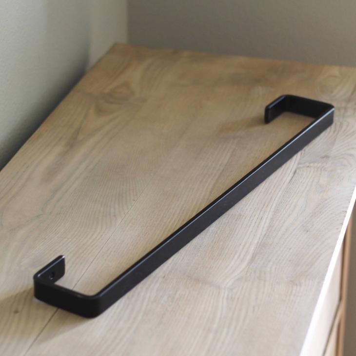 industrial metal towel bar on wood tabletop