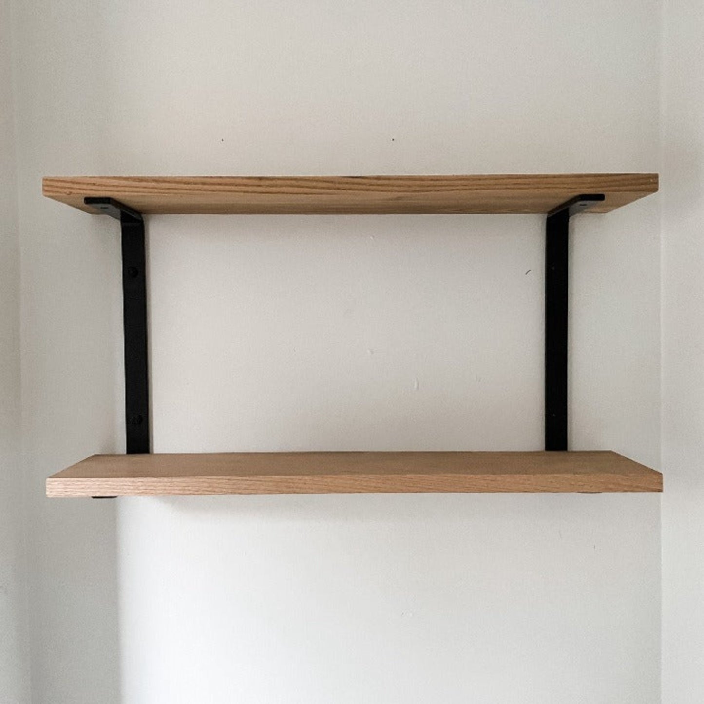 two wood shelves made with metal c bracket