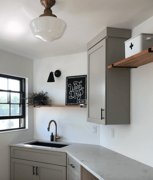 Update laundry room with cabinet and two wood shelves mounted with raw steel metal brackets