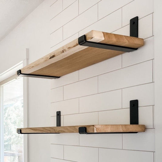 Kitchen with two large oak wood shelves installed onto white tile backsplash with black heavy duty J style brackets