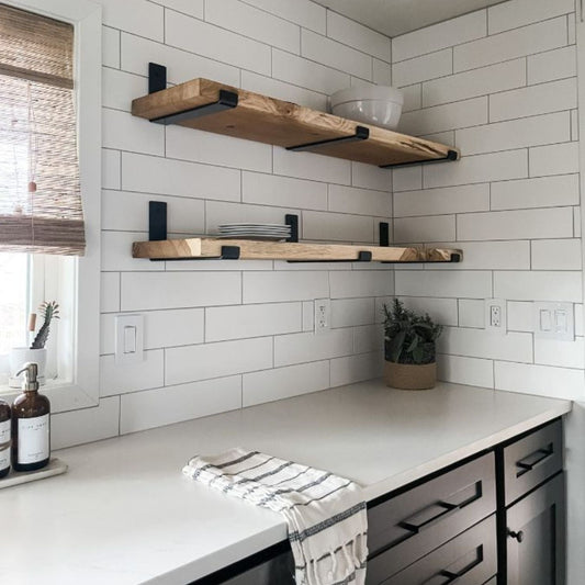 kitchen with two wood shelves mounted with black brackets on white tile