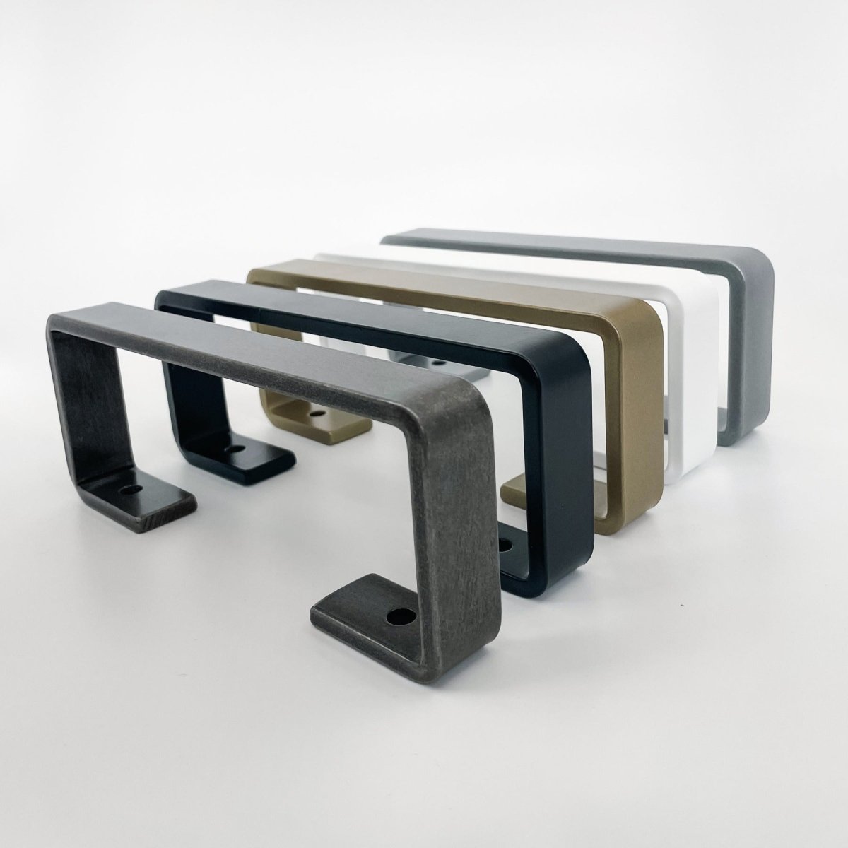 five metal towel bars in a U shape design lined up in various colors including steel, black, grass gold, white, and silver