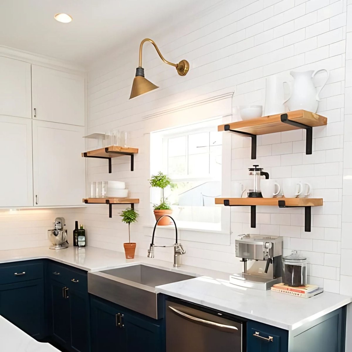 modern kitchen with four wood shelves mounted with black Z brackets on white tile backsplash. There is a sconce and decor