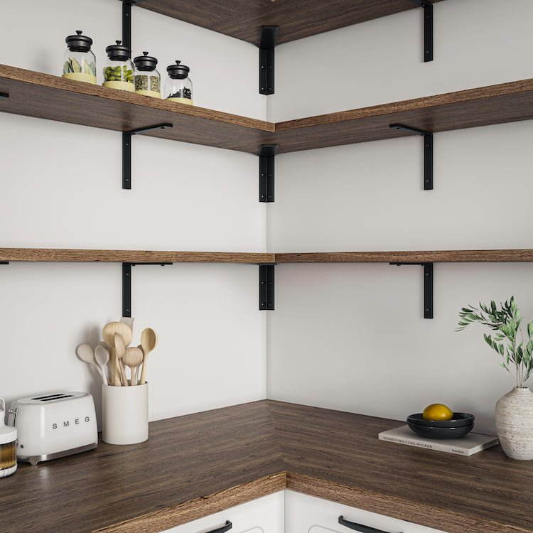 Three wood kitchen shelves with regular and corner brackets mounted on wall with various kitchen decor