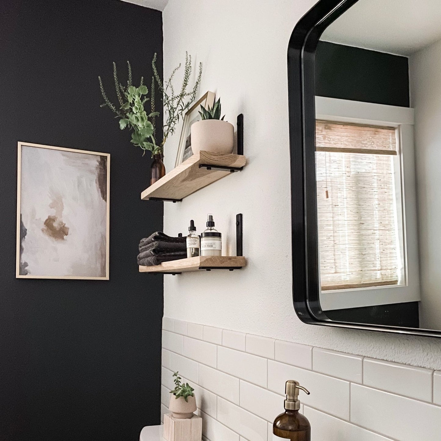 bathroom with black wall and wood shelves