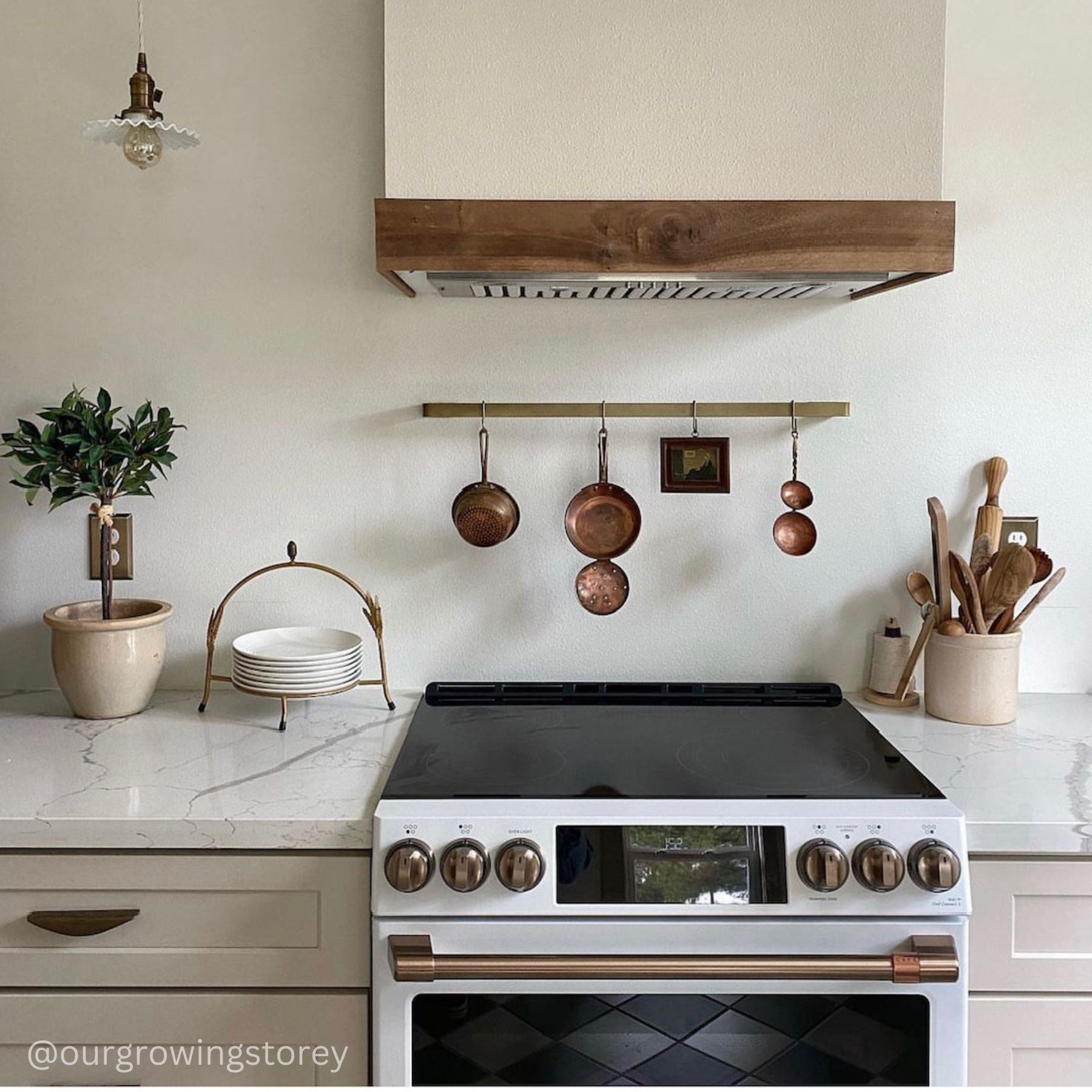 brass utensil holder in kitchen