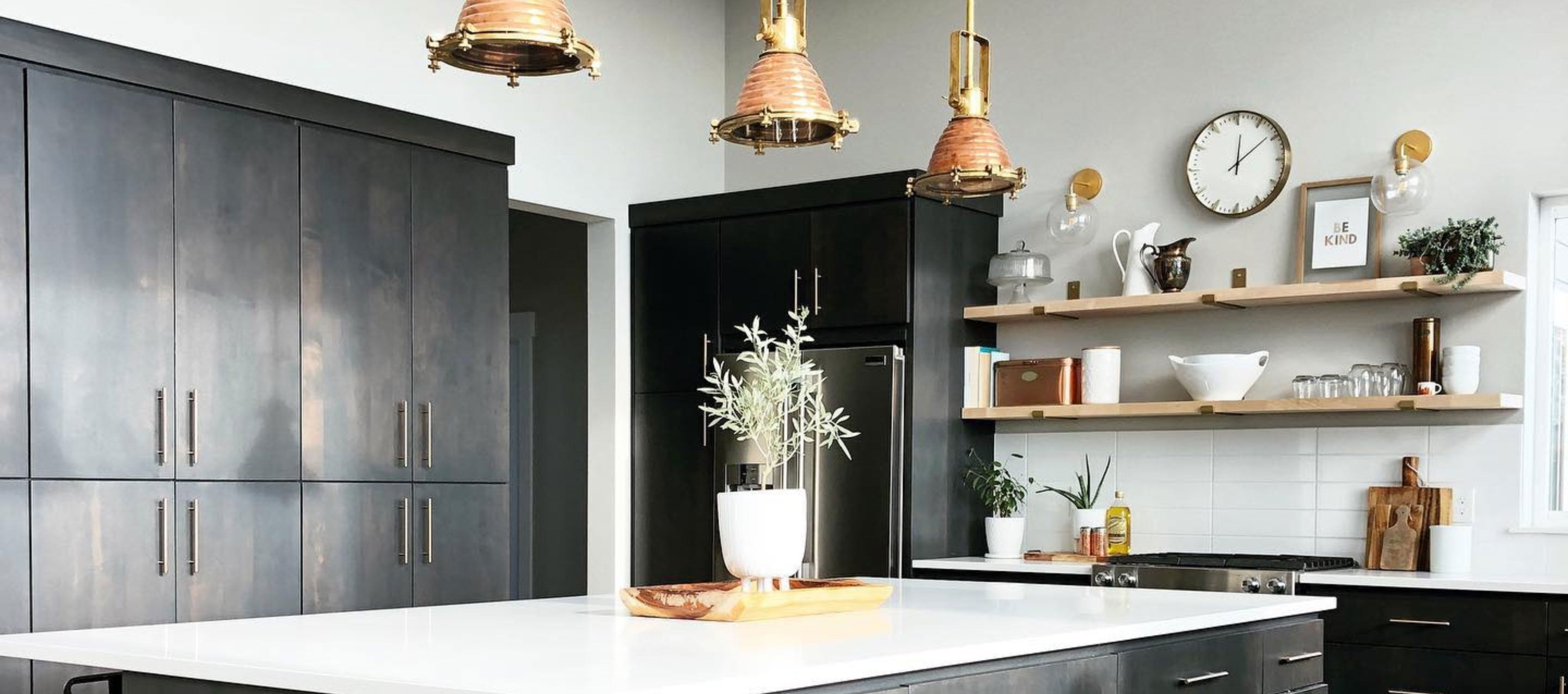 modern black kitchen with wood shelves and brass shelf brackets