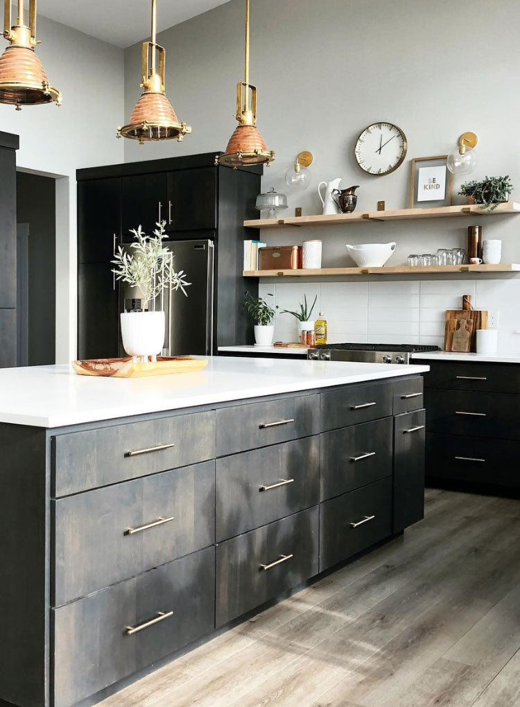 black kitchen with wood shelves and brass shelf brackets