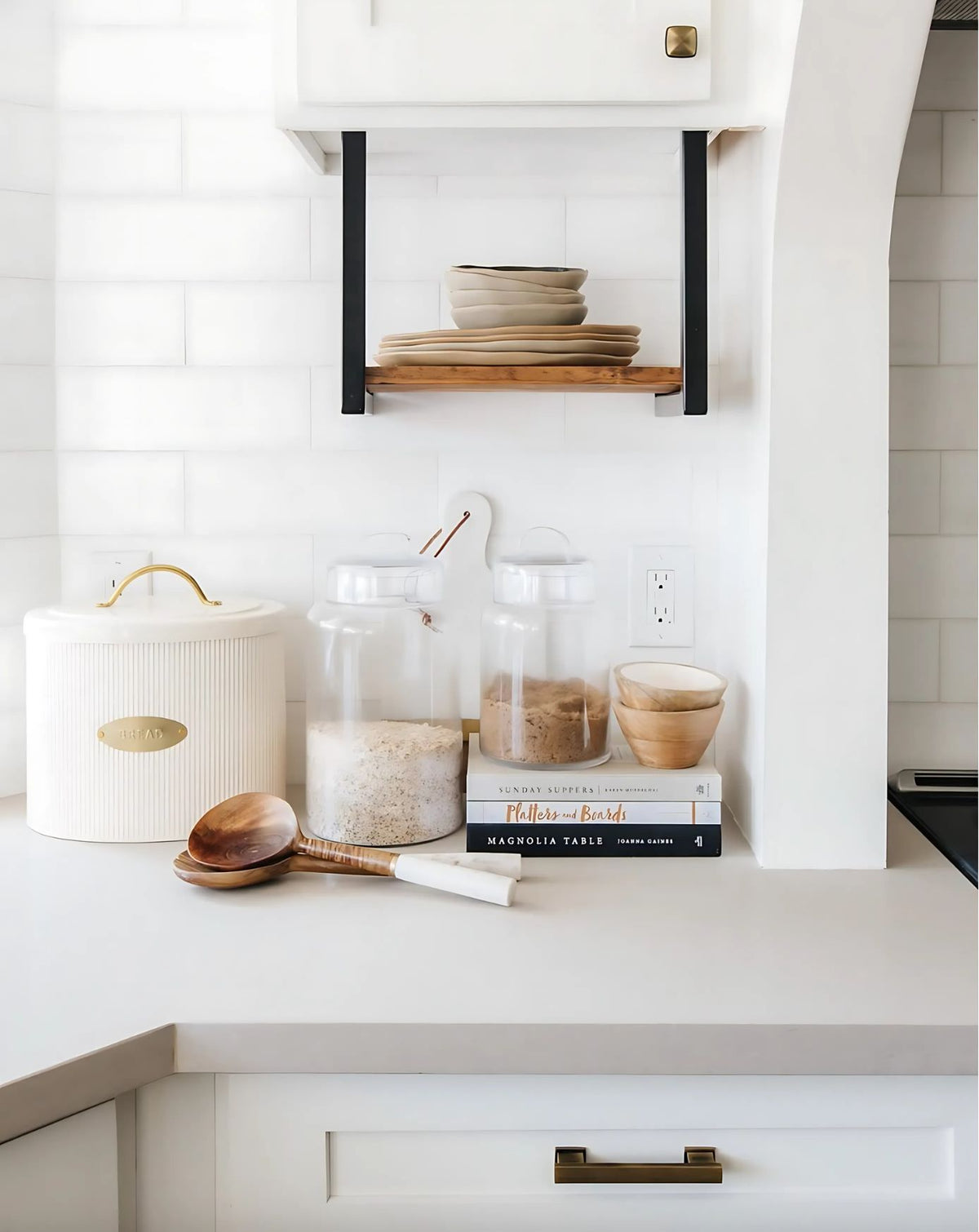 kitchen with custom wood shelf and black bracket hanging below cabinet
