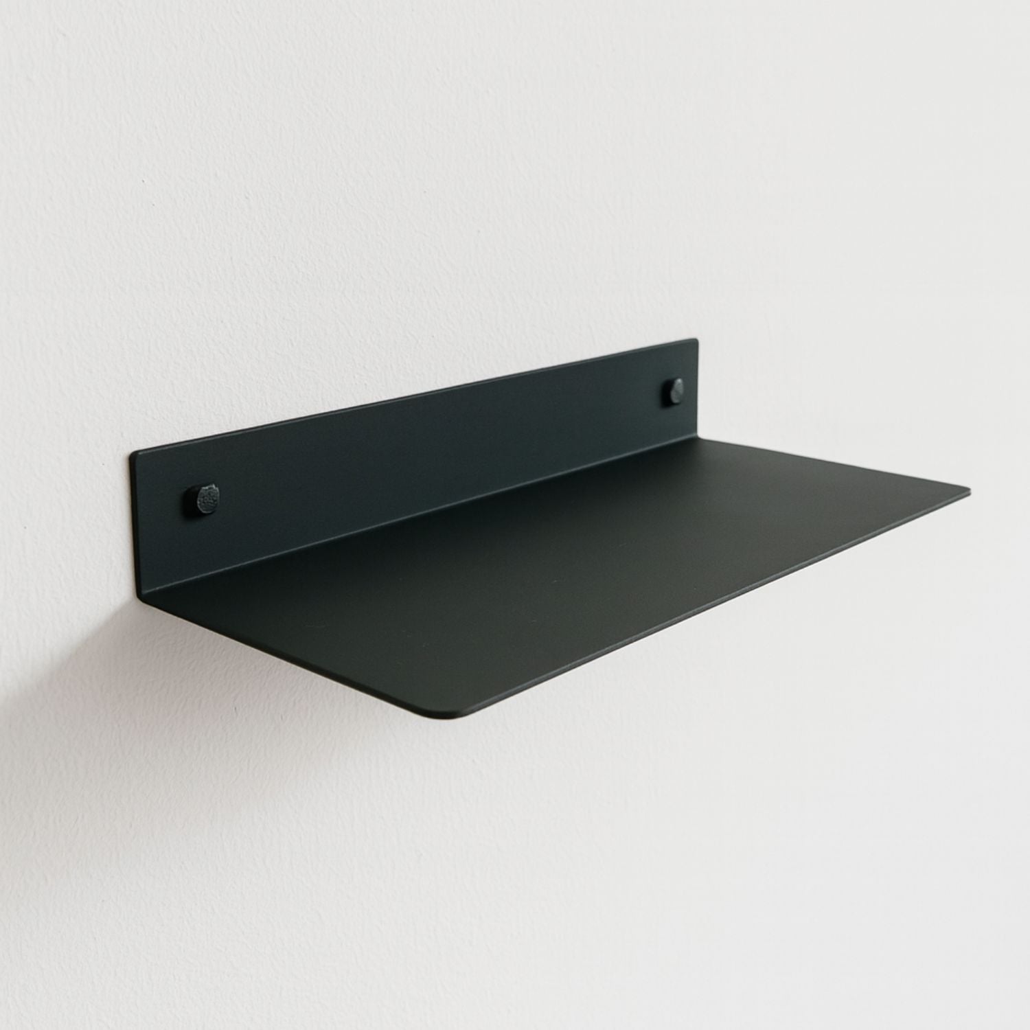 green metal shelf mounted on wall