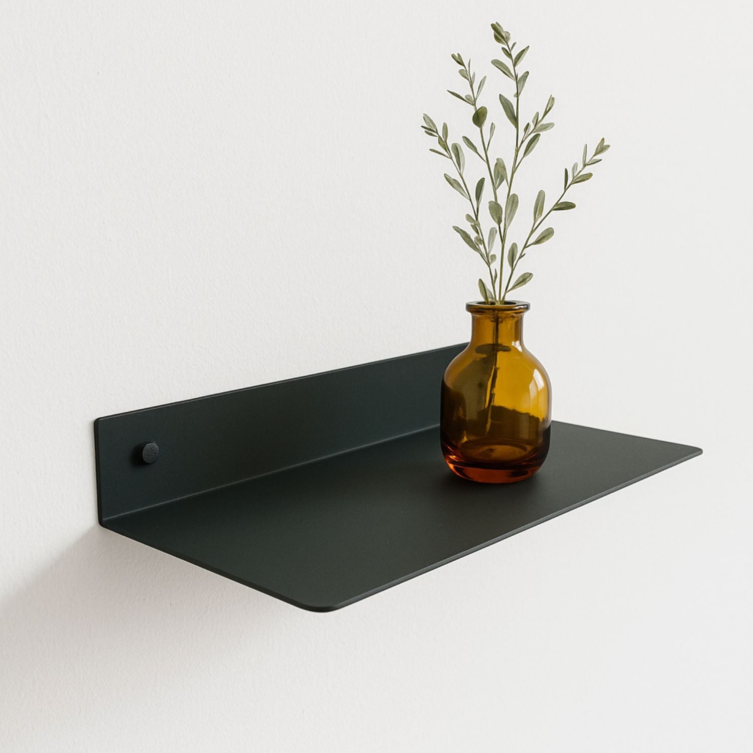 floating green metal shelf mounted on wall with amber glass vase 