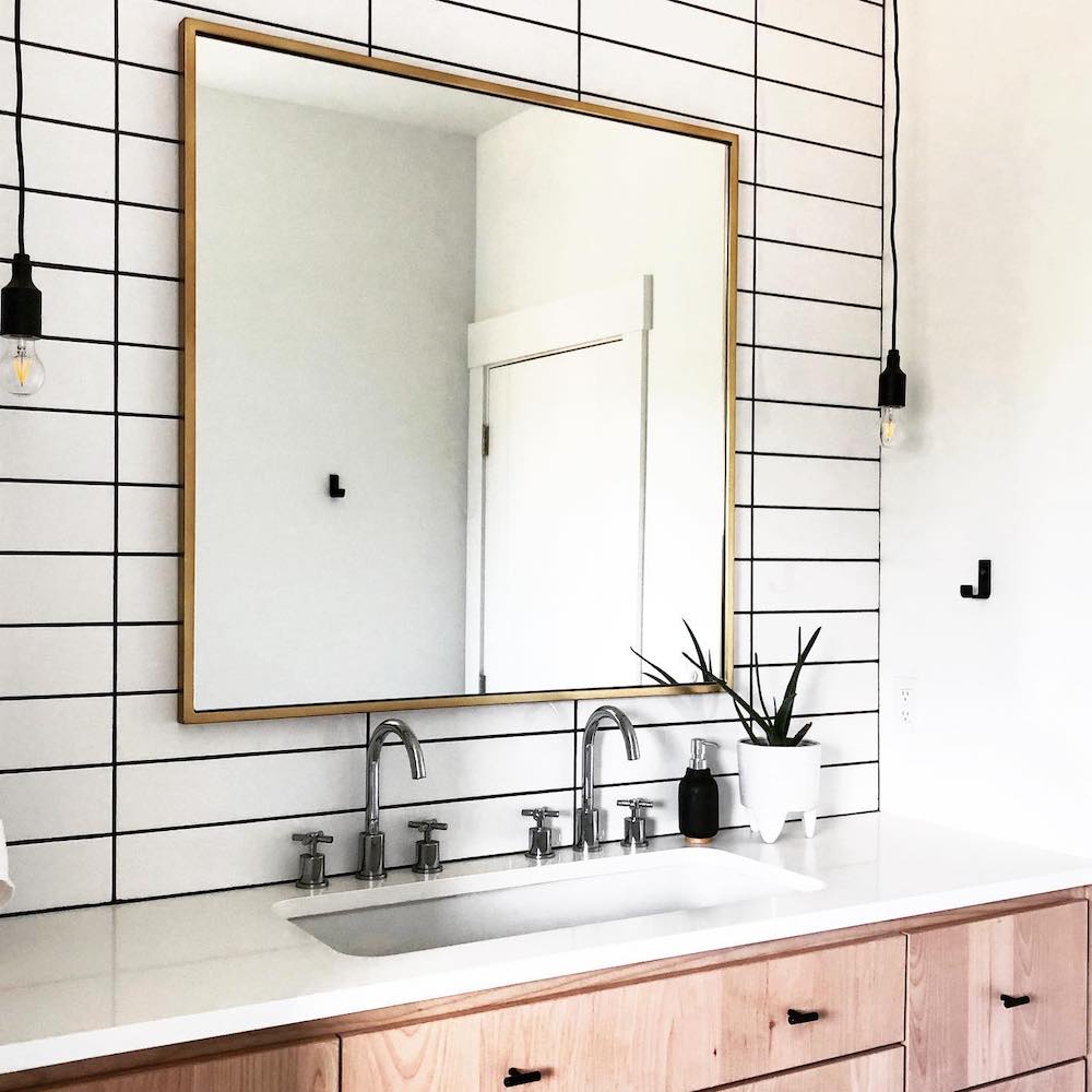 white modern bathroom with black hook