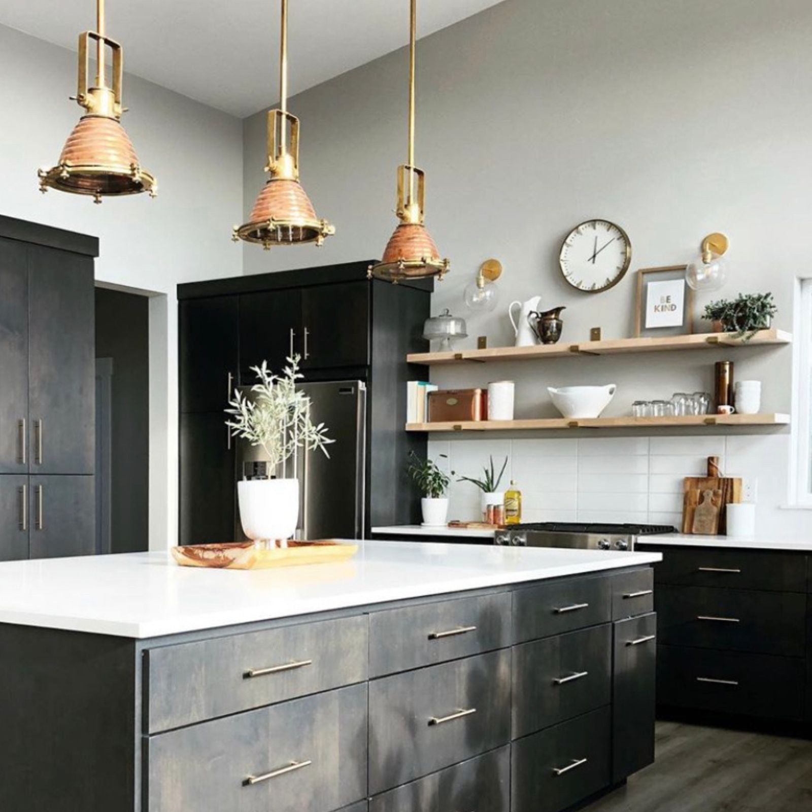 black kitchen with gold shelf brackets and wood shelves