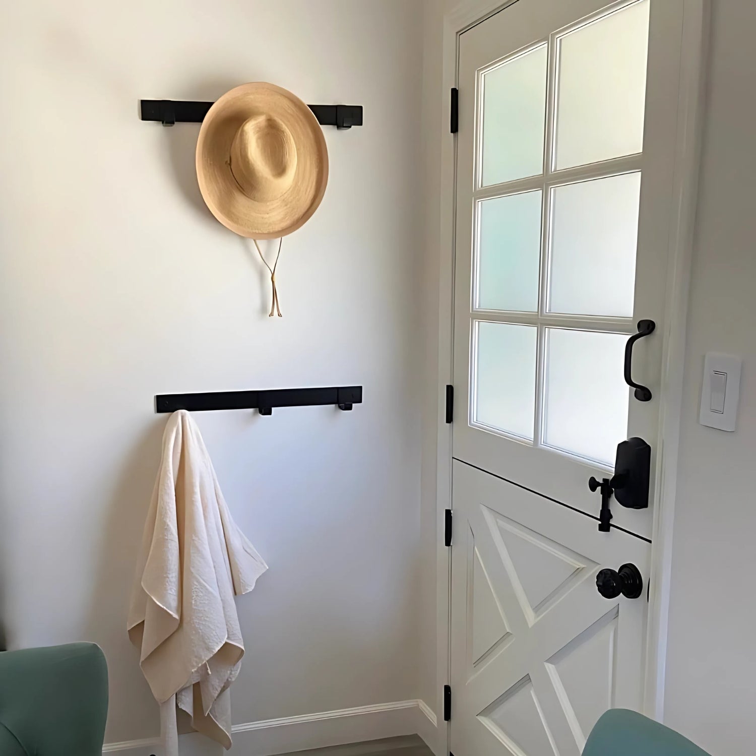 entryway with black coat racks