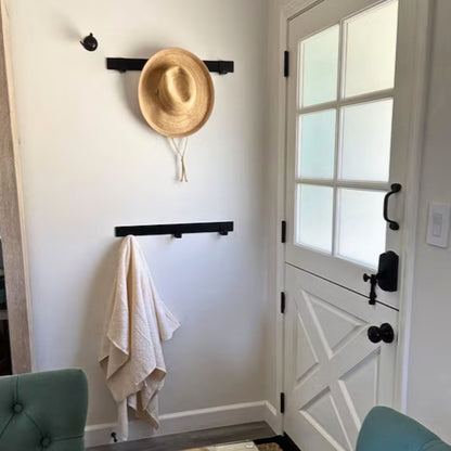 entryway with black coat racks