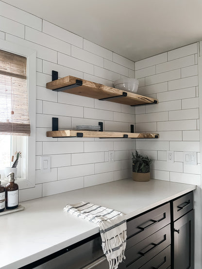 black and white kitchen with wood shelves