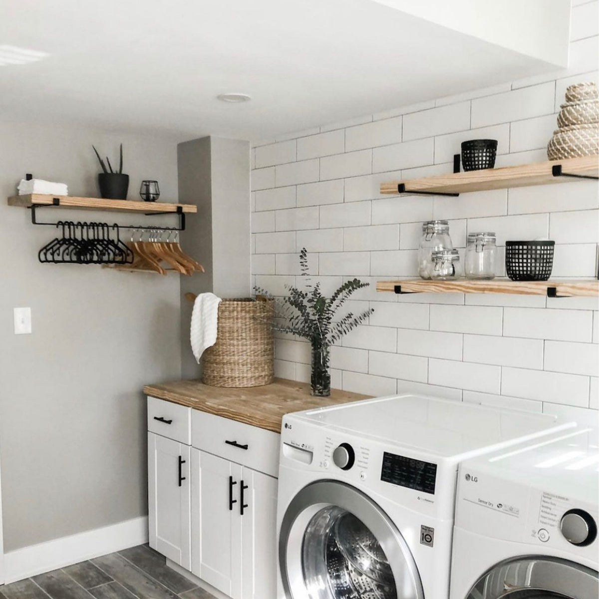 white laundry room with shelves and drying rack