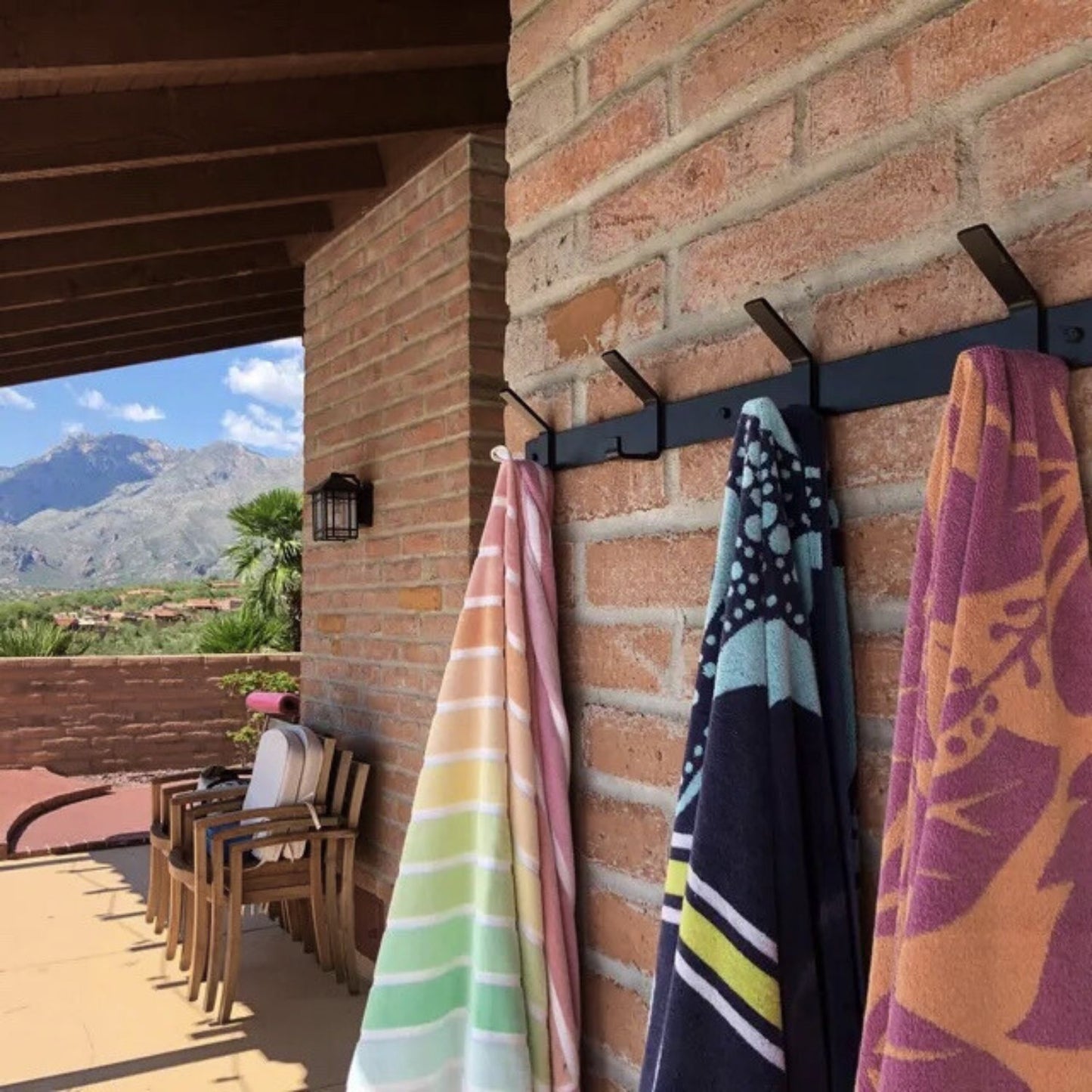 outdoor brick wall with towel rack