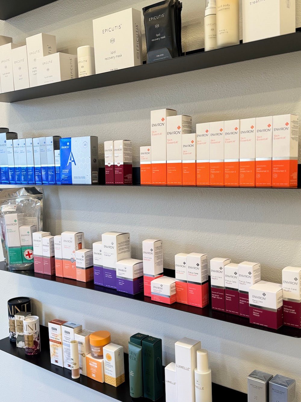 Floating metal shelves with various cosmetic products and boxes in a salon setting