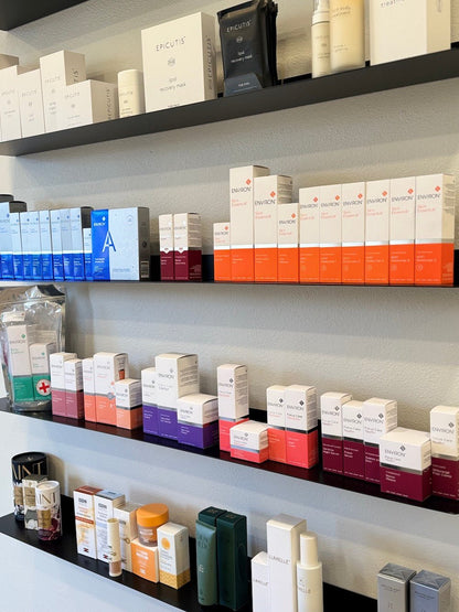 Floating metal shelves with various cosmetic products and boxes in a salon setting