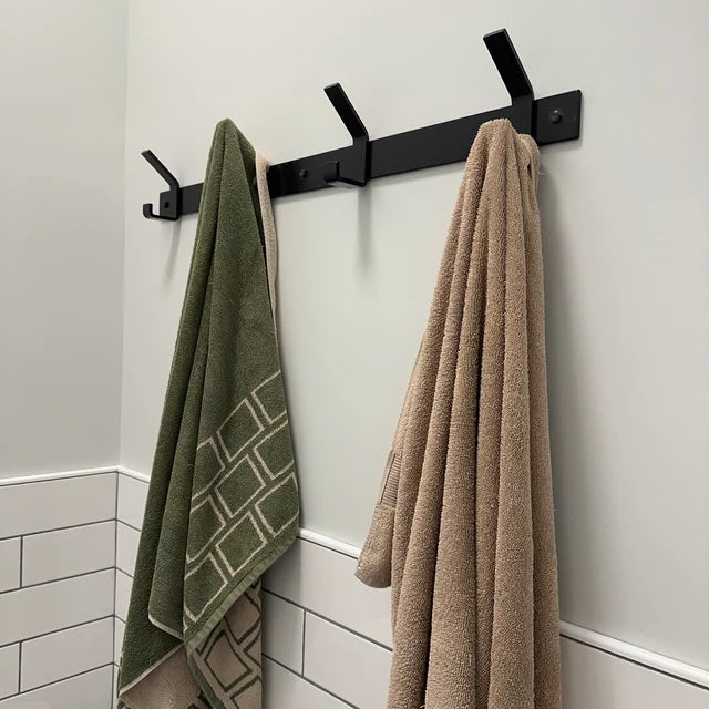 black towel rack on wall