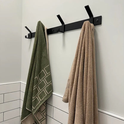 black towel rack on bathroom wall