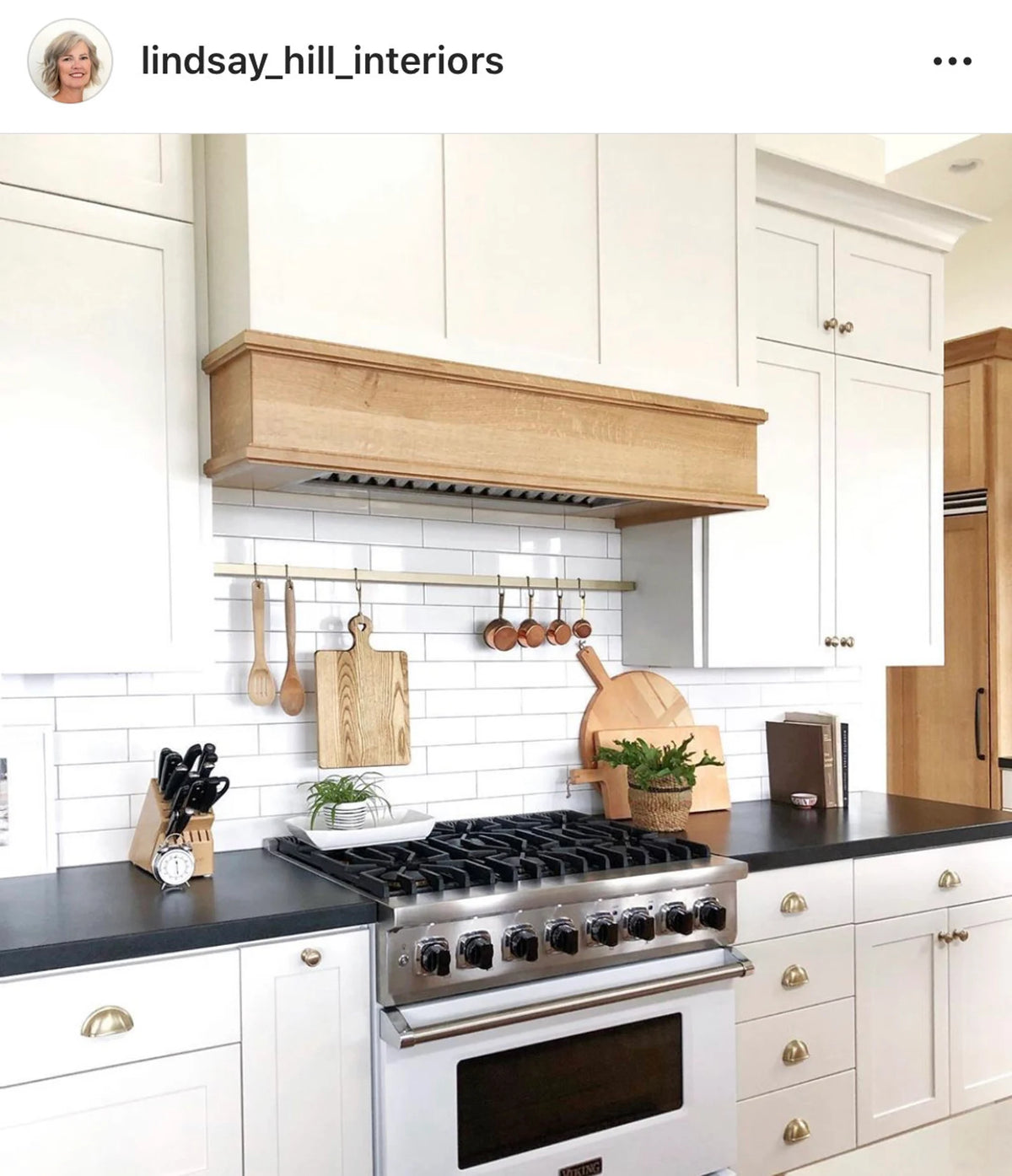 kitchen with gold utensil bar above stove
